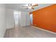 Bright bedroom features hard surface floors, orange accent wall, and access to a closet at 545 Barnette Rd, Louisburg, NC 27549
