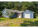 Blue house featuring an attached garage, yard, and classic design at 545 Barnette Rd, Louisburg, NC 27549