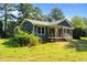 Charming blue home featuring a cozy front porch and well-maintained lawn at 545 Barnette Rd, Louisburg, NC 27549