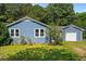 Blue house featuring an attached garage, yard, and classic design at 545 Barnette Rd, Louisburg, NC 27549