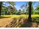 A view of the exterior of a charming home with a well-maintained lawn and mature trees in a serene setting at 545 Barnette Rd, Louisburg, NC 27549