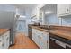 Kitchen featuring white cabinets, dark countertops, and stainless steel fridge at 545 Barnette Rd, Louisburg, NC 27549