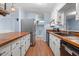 Spacious kitchen with butcher block counters and stainless steel refrigerator at 545 Barnette Rd, Louisburg, NC 27549