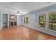Bright living room featuring hardwood floors, a ceiling fan, and natural light at 545 Barnette Rd, Louisburg, NC 27549