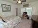 Cozy bedroom with floral bedding, ceiling fan, and carpet flooring at 555 Hinnant Rd, Selma, NC 27576