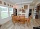 Bright dining room featuring a wooden table set, light wood floors, and a Tiffany-style pendant lamp at 555 Hinnant Rd, Selma, NC 27576