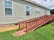 Home exterior featuring a wooden wheelchair ramp for accessible entry at 555 Hinnant Rd, Selma, NC 27576