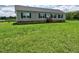 Charming one-story home featuring black shutters, a large front yard, and gray siding at 555 Hinnant Rd, Selma, NC 27576