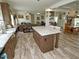 Bright open concept kitchen with wood cabinets, a kitchen island, and hardwood floors at 555 Hinnant Rd, Selma, NC 27576