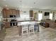 Open-concept kitchen with a marble top island, stainless steel appliances, and hardwood flooring at 555 Hinnant Rd, Selma, NC 27576
