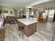 Spacious kitchen with island seating that flows into a cozy living and dining area at 555 Hinnant Rd, Selma, NC 27576