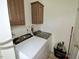 Functional laundry room featuring a white washer and dryer set and wooden cabinets at 555 Hinnant Rd, Selma, NC 27576