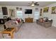 Inviting living room with plush sofas, a ceiling fan and plenty of natural light at 555 Hinnant Rd, Selma, NC 27576
