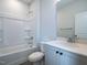 This bathroom offers a single sink vanity and a shower-tub combination with tile surround and modern fixtures at 1221 Barreto Dr, Wendell, NC 27591