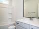 Bathroom features a tub, white vanity with quartz countertop and a large mirror at 1221 Barreto Dr, Wendell, NC 27591