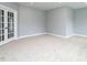 Spacious carpeted room featuring recessed lights, neutral walls and french doors providing an open and airy feel at 1221 Barreto Dr, Wendell, NC 27591