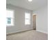 This bedroom is a clean, carpeted space featuring two windows for plenty of natural light and a neutral color palette at 1221 Barreto Dr, Wendell, NC 27591