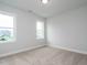 Empty bedroom features neutral carpet, gray walls and two large windows at 1221 Barreto Dr, Wendell, NC 27591