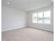 Empty bedroom features neutral carpet, gray walls and a large window at 1221 Barreto Dr, Wendell, NC 27591
