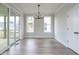 Elegant dining room with sliding doors to a deck, modern lighting fixture, and neutral walls at 1221 Barreto Dr, Wendell, NC 27591
