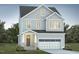 Charming two-story home with gray siding, attached garage, and landscaped lawn at 1221 Barreto Dr, Wendell, NC 27591