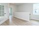 Hallway features glass french doors, gray walls and wood floors at 1221 Barreto Dr, Wendell, NC 27591