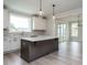 Bright kitchen features a large center island with white cabinets and stainless steel appliances at 1221 Barreto Dr, Wendell, NC 27591