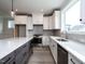 This kitchen features stone countertops, stainless steel appliances, and an island with barstool seating at 1221 Barreto Dr, Wendell, NC 27591