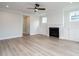 Open-concept living room featuring a fireplace, built-in cabinets, ceiling fan, and wood floors at 1221 Barreto Dr, Wendell, NC 27591