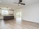 Spacious open living area with ceiling fan, kitchen with island and access to covered porch at 1221 Barreto Dr, Wendell, NC 27591