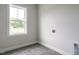 Neutral room with tiled floor and a window providing natural light; washer-dryer hookups are available at 1221 Barreto Dr, Wendell, NC 27591