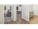 A modern bedroom with neutral colors and hardwood floors visible through a set of double doors at 1234 Sirius Lot 6 Dr, Sanford, NC 27330