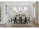 Formal dining room with elegant table setting, stylish chairs, wainscoting, and natural light at 1234 Sirius Lot 6 Dr, Sanford, NC 27330