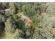 Secluded property with beautiful landscaping, bordered by lush trees and a serene outdoor dining area at 133 Acorn Ln, Pittsboro, NC 27312