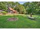 Spacious backyard with a hammock, mature trees, and lush greenery, offering a peaceful retreat at 133 Acorn Ln, Pittsboro, NC 27312