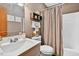 Well-lit bathroom featuring a vanity with a sink, toilet, and shower with curtain at 133 Acorn Ln, Pittsboro, NC 27312