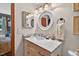 Charming bathroom features a marble countertop, round mirror, and is adjacent to the main bedroom at 133 Acorn Ln, Pittsboro, NC 27312