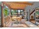 Charming covered deck featuring dining table and view to private backyard at 133 Acorn Ln, Pittsboro, NC 27312