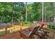 Outdoor deck offering lounge chairs, wooded views and an idyllic space for relaxing and enjoying the scenery at 133 Acorn Ln, Pittsboro, NC 27312