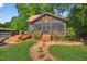 Charming screened-in porch with multiple entrances, complemented by a stone path and grassy lawn at 133 Acorn Ln, Pittsboro, NC 27312
