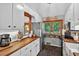Bright kitchen with butcher block countertops, white cabinets, and a view of the outdoor scenery at 133 Acorn Ln, Pittsboro, NC 27312