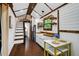 Stylish tiny home kitchen featuring wood countertops, white cabinets, and modern appliances at 133 Acorn Ln, Pittsboro, NC 27312