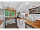 Charming kitchen with butcher block countertops, white cabinetry, and stainless steel appliances at 133 Acorn Ln, Pittsboro, NC 27312