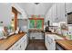 Charming kitchen with butcher block countertops, white cabinetry, and stainless steel appliances at 133 Acorn Ln, Pittsboro, NC 27312
