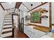 Well-designed tiny home kitchen with wood countertops, white cabinets, and a cozy dining area at 133 Acorn Ln, Pittsboro, NC 27312