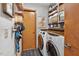 Well-organized laundry room with modern washer/dryer, wooden countertop and ample storage shelves at 133 Acorn Ln, Pittsboro, NC 27312