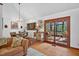 Cozy living room featuring hardwood floors, natural light, and access to a screened porch at 133 Acorn Ln, Pittsboro, NC 27312