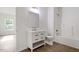 Bright bathroom features white cabinets, drawers, and bathtub with updated fixtures over wood grain floors at 1408 South St, Durham, NC 27707