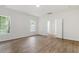 Spacious bedroom featuring hardwood floors, a ceiling light, and a double-door closet at 1408 South St, Durham, NC 27707