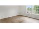 Bright bedroom features wood grain floors and double windows overlooking the front yard and neighborhood at 1408 South St, Durham, NC 27707